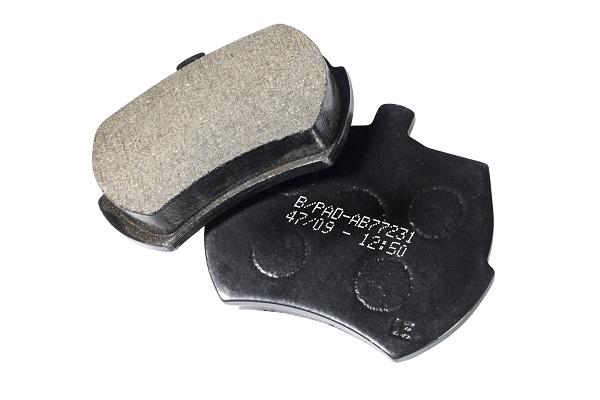 Two new brake pads for a vehicle.