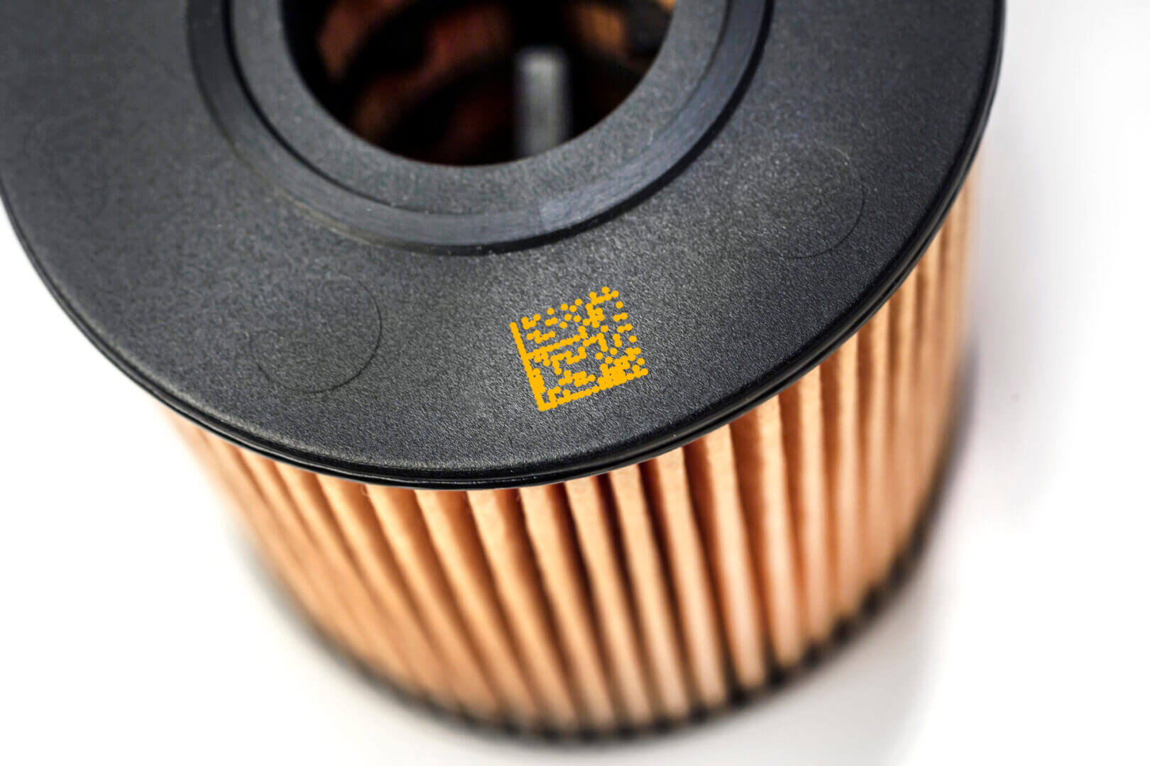 Black and brown oil filter with code.