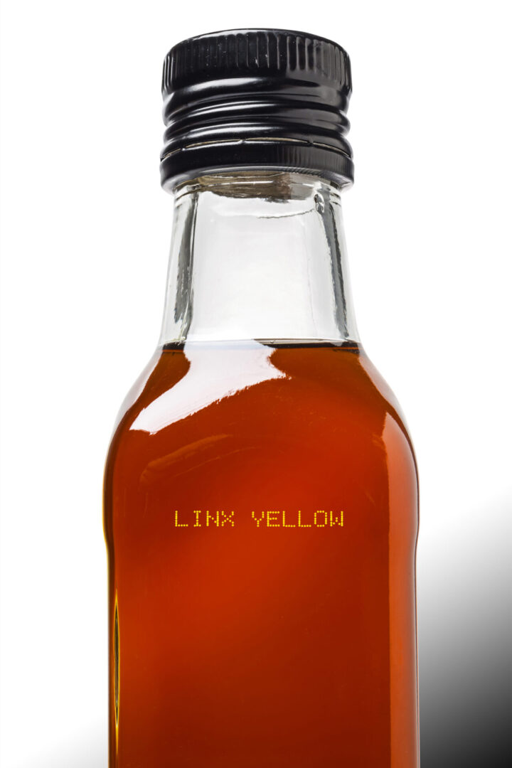 Glass bottle of amber-colored liquid.