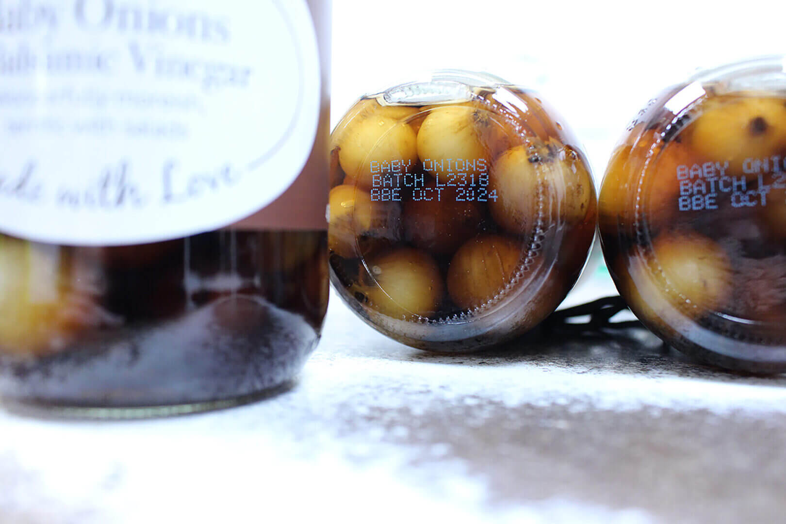 Two jars of pickled baby onions.